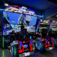 Load image into Gallery viewer, Twin racing arcade machines with players and city race screens
